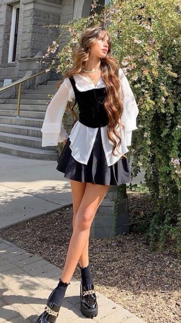 Black Corset Over White Blouse with Pleated Skirt